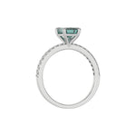 This white gold ring displayed in through finger  view is made with a emerald solitaire diamond set in four-prong setting