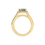 This yellow gold Cushion Diamond Halo Engagement Ring is made with a fancy green cushion solitaire diamond set in a four-prong setting in through finger view