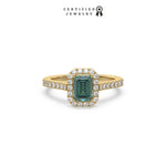 This yellow gold ring displayed in front view is made with a Emerald solitaire diamond set in four-prong setting