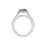 This white gold Emerald Diamond Halo Engagement Ring is made with a fancy green emerald solitaire diamond set in a four-prong setting in through finger view