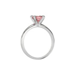 This white gold ring features a fancy Pink cushion solitaire diamond elegantly secured in a four-prong setting on a solid gold band in through finger view