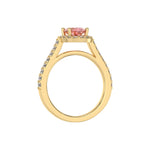 This yellow gold Oval Diamond Halo Engagement Ring is made with a fancy pink oval solitaire diamond set in a four-prong setting, surrounded by a halo of round diamonds all set on a pave band in through finger view