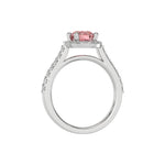 This white gold Round Diamond Halo Engagement Ring is made with a fancy Pink round solitaire diamond set in a four-prong setting in through finger view