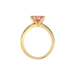 This yellow gold ring features a fancy Pink round solitaire diamond elegantly secured in a four-prong setting on a solid gold band in through finger view