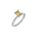 This white gold ring features an fancy Yellow emerald solitaire diamond elegantly secured in a four-prong setting on a solid gold band in 3D view