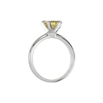 This white gold ring features an fancy Yellow emerald solitaire diamond elegantly secured in a four-prong setting on a solid gold band in through finger view