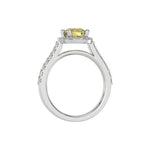 This white gold Round Diamond Halo Engagement Ring is made with a fancy Yellow round solitaire diamond set in a four-prong setting in through finger view