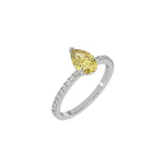 This white gold ring is made with a fancy Yellow pear solitaire diamond set in three-prong setting, and is complemented by a round pave diamonds band in 3D view