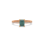 This rose gold ring displayed in front view is made with a emerald solitaire diamond set in four-prong setting