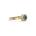 This yellow gold ring displayed on side view is made with brilliant round solitaire diamond set in bezel setting