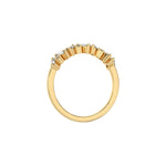 This yellow gold ring displayed on through finger view is made with round brilliant-cut diamonds and baguette set in a prong setting