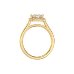 This yellow gold ring features a cushion solitaire diamond set in a four-prong setting, surrounded by a halo of round diamonds, all resting on a delicate gold band in through finger view