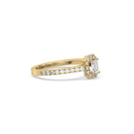 This yellow gold ring displayed in side view is made with a Emerald solitaire diamond set in four-prong setting