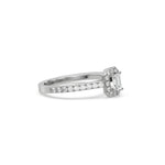 This white gold ring displayed in side view is made with a Emerald solitaire diamond set in four-prong setting