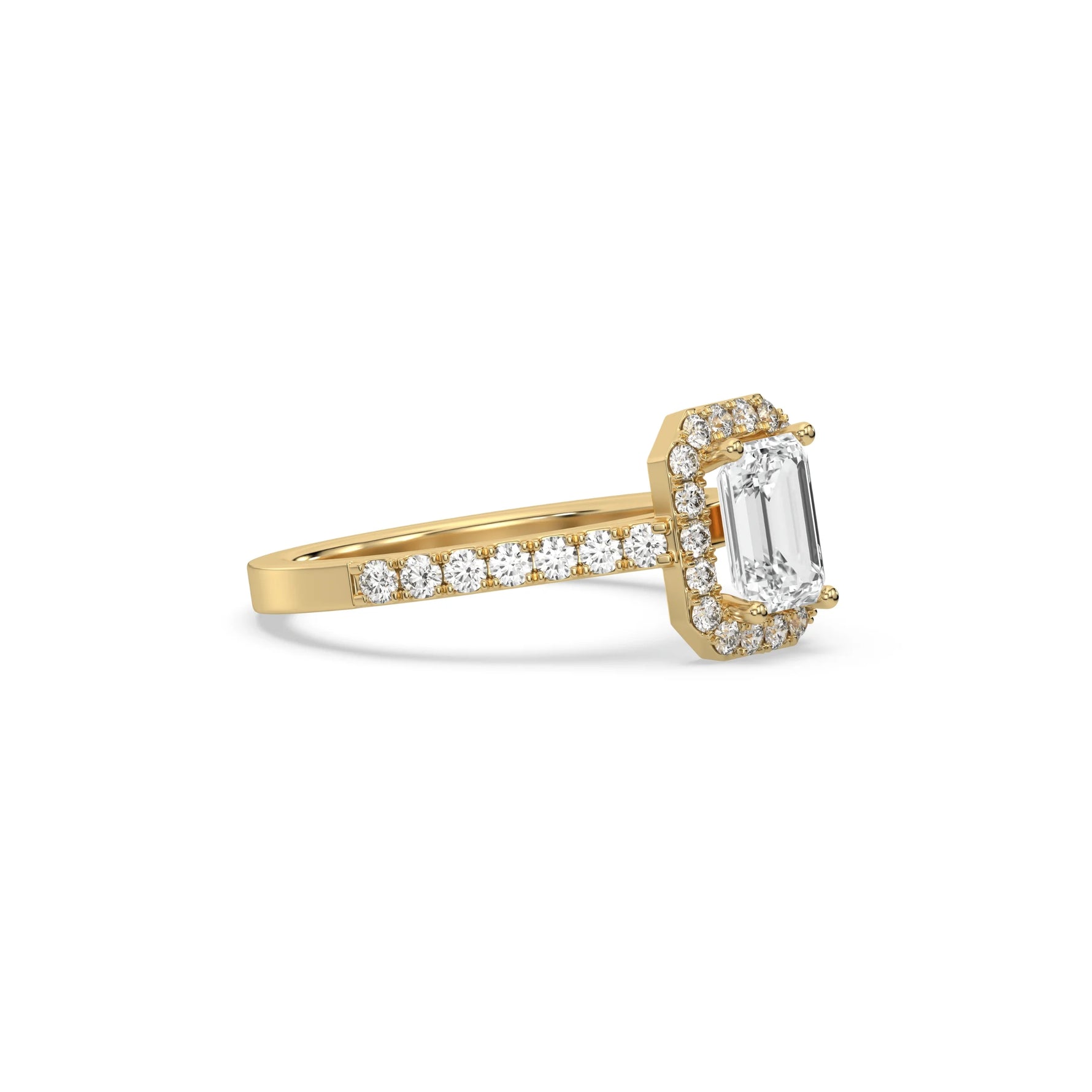 This yellow gold ring displayed in side view is made with a Emerald solitaire diamond set in four-prong setting