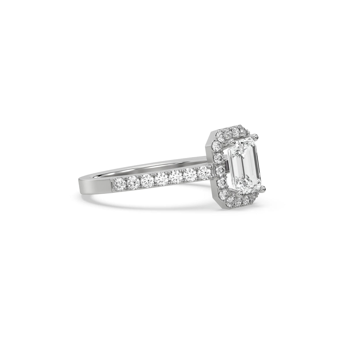 This white gold ring displayed in side view is made with a Emerald solitaire diamond set in four-prong setting