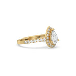 This yellow gold ring displayed in side view is made with a pear solitaire diamond set in four-prong setting