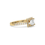 This yellow gold ring displayed in side view is made with a princess solitaire diamond set in four-prong setting