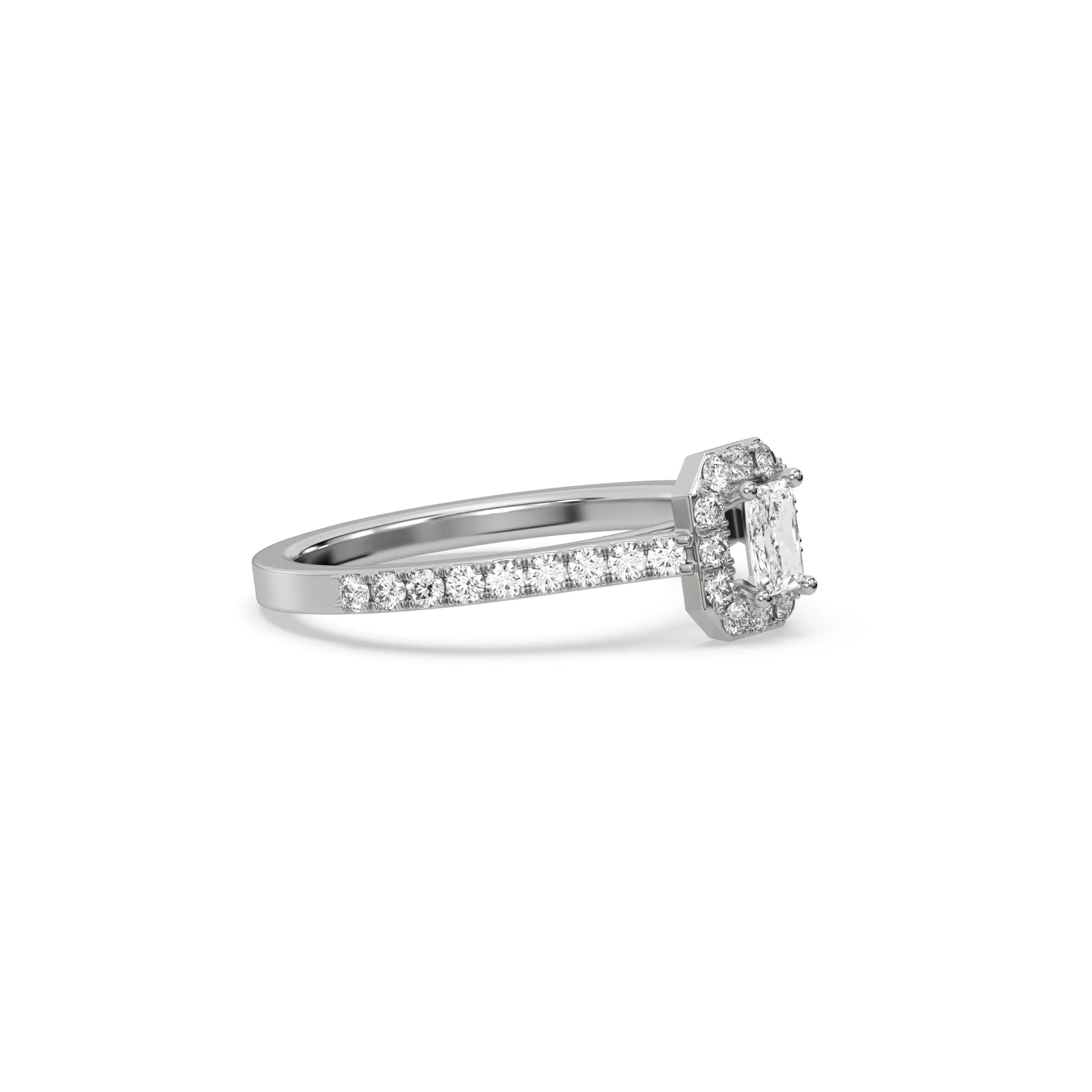 This white gold ring displayed in side view is made with a radiant solitaire diamond set in four-prong setting