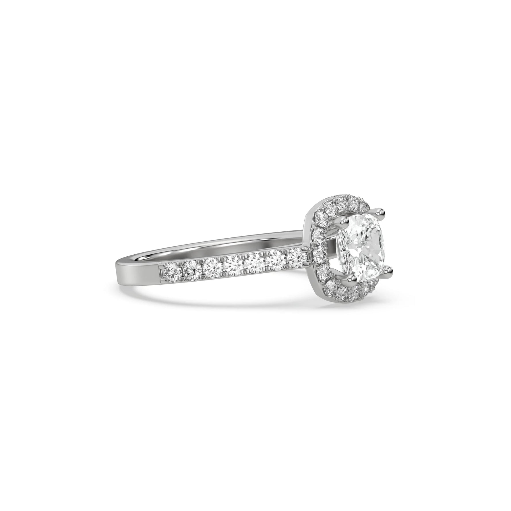 This white gold ring displayed in side view is made with a cushion solitaire diamond set in four-prong setting