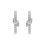 Pair of vertical bar studs in yellow gold featuring a marquise cluster accent and a prong-set round diamond stud earring design with sparkling stones with a white background.