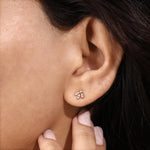 Close-up of a woman wearing a yellow gold marquise and round diamond lotus cluster stud earring to show real-life product scale, fit, and style.