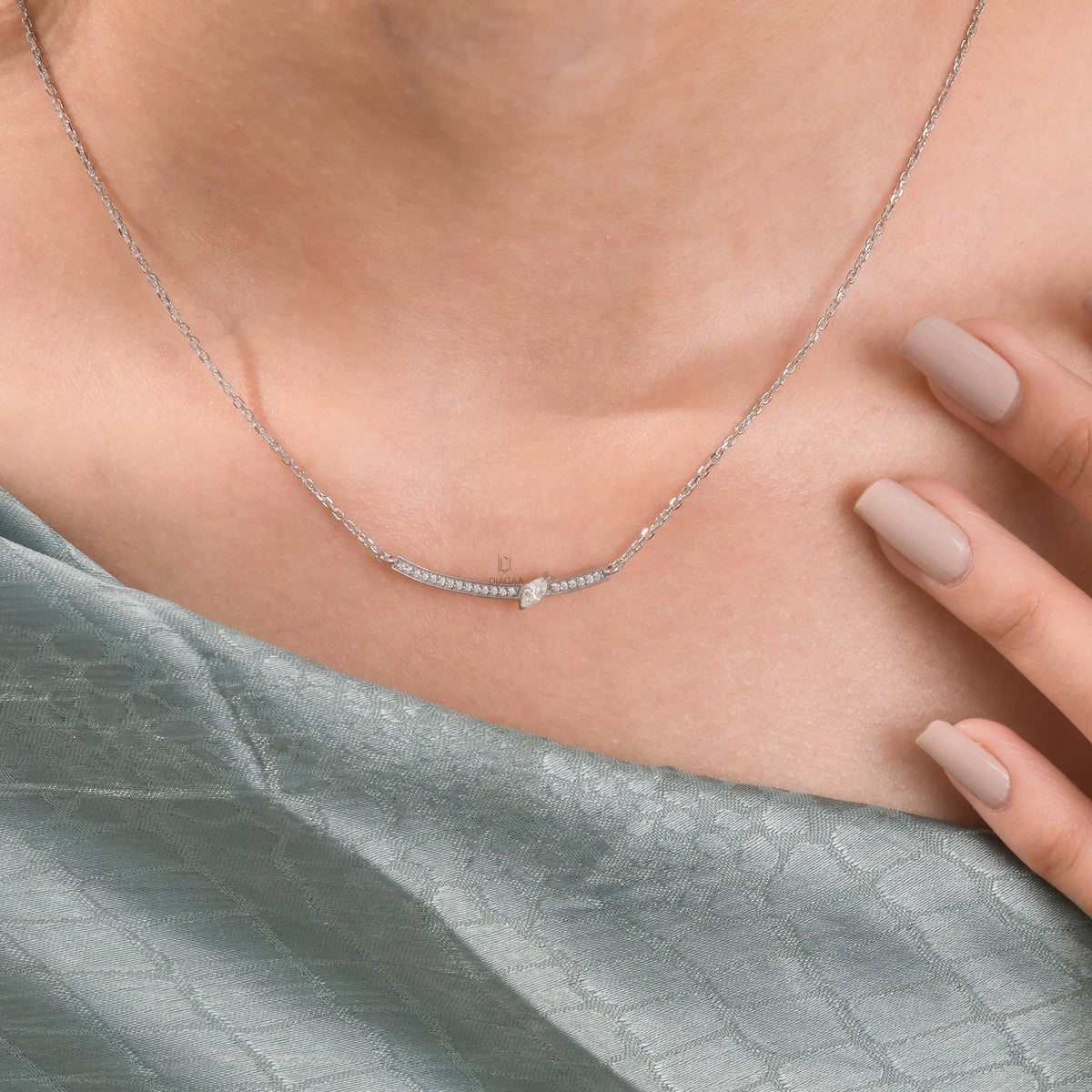 Woman wearing a delicate Round and Marquise diamond necklace featuring a curved bar with prong and pave-set stones in yellow gold.