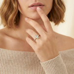 Model lifestyle photo of a 18k gold marquise diamond ring featuring a secure low-profile bezel setting and micro-pavé band, showcasing luxury jewelry on a hand.