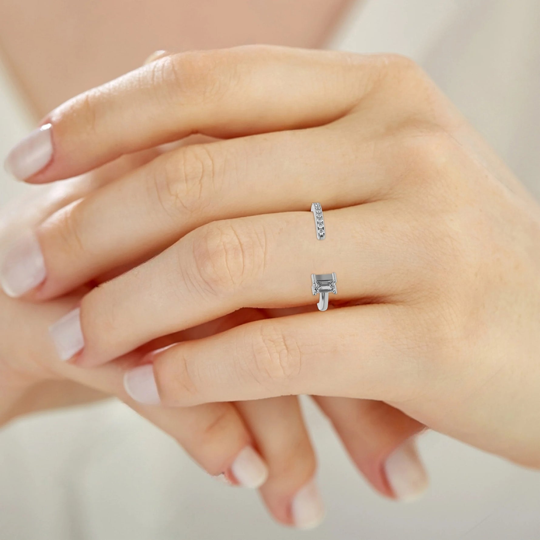 This white gold Open Emerald Diamond ring features an open gap in the center. One side with a 0.15 CT emerald solitaire in a four prong setting, while the other side sparkles with 9 round brilliant-cut diamonds set in a micro-pave setting on ring finger