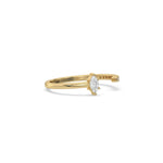 This yellow gold ring displayed on side view is made with marquise diamond and round diamond set in prong setting 