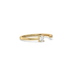 This yellow gold ring displayed on side view is made with emerald diamond and round diamond set in prong setting 