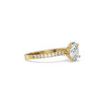 This yellow gold ring displayed in side view is made with a oval solitaire diamond set in four-prong setting