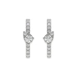 Pair of vertical bar studs in white gold featuring a center pear-accented cluster and a pave-set round diamond stud earring design with sparkling stones.