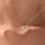 Model wearing a classic white gold Pear Diamond necklace featuring a teardrop bezel-set solitaire pendant.
