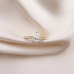 This yellow gold ring displayed in front view is made with a Pear solitaire diamond set in four-prong setting