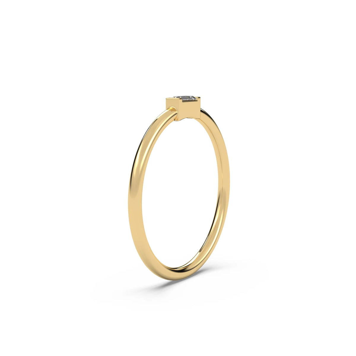 This yellow gold A thin gold band showcases a baguette diamond held in a bar prong setting in side view