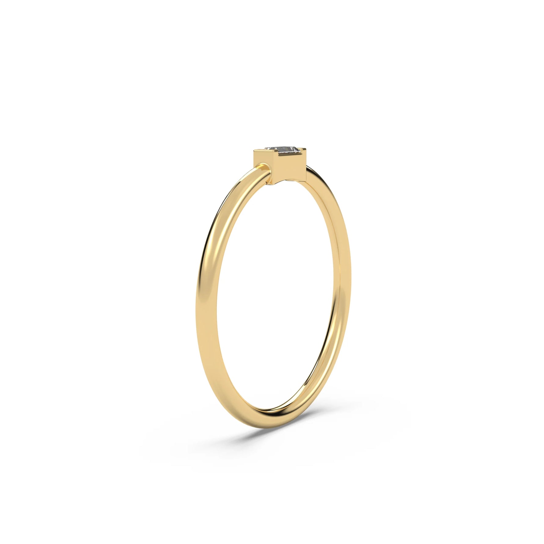 This yellow gold A thin gold band showcases a baguette diamond held in a bar prong setting in side view