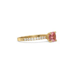 This yellow gold ring displayed in side view is made with a cushion solitaire diamond set in four-prong setting