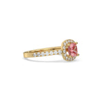 This yellow gold ring displayed in side view is made with a cushion solitaire diamond set in four-prong setting