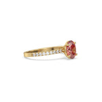 This yellow gold ring displayed in side view is made with a oval solitaire diamond set in four-prong setting