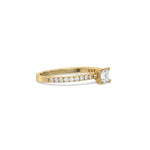 This yellow gold ring displayed in side view is made with a princess solitaire diamond set in four-prong setting