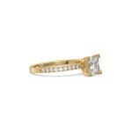 This yellow gold ring displayed in side view is made with a princess solitaire diamond set in four-prong setting