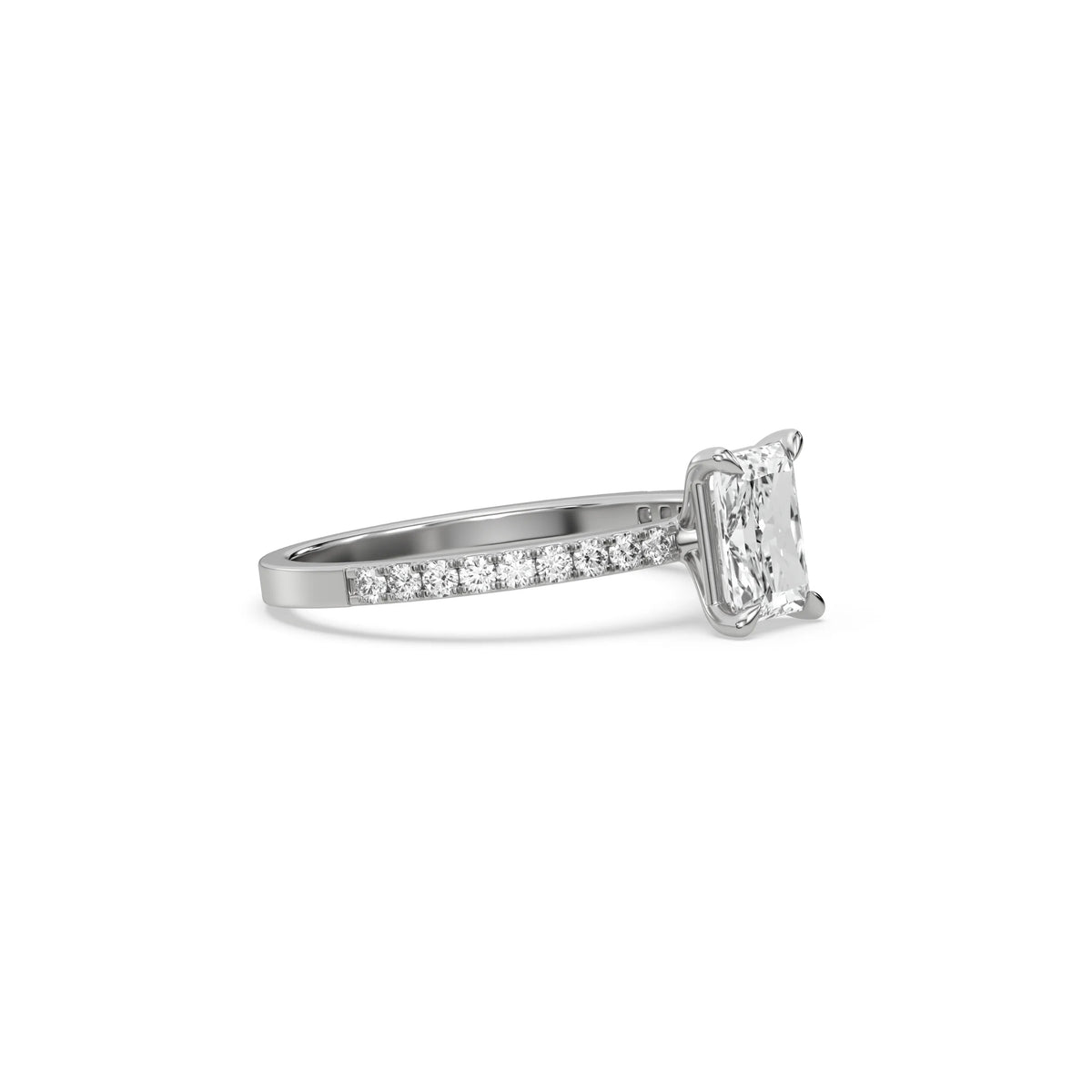 This white gold ring displayed in side view is made with a radiant solitaire diamond set in four-prong setting