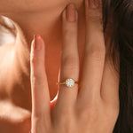 Minimalist 14k yellow gold bezel solitaire diamond ring showcasing a brilliant round-cut center stone on a classic tapered gold band for a sleek look.