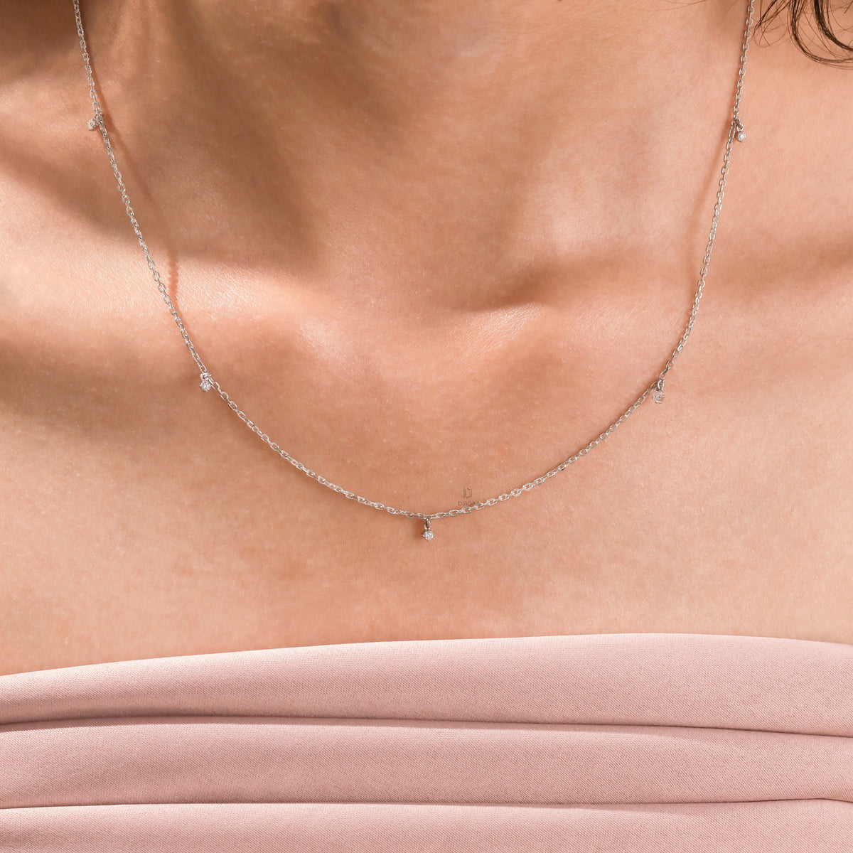 Close-up view of a yellow gold Round diamond Dangling necklace featuring multiple small prong-set round diamond charms suspended on a fine chain