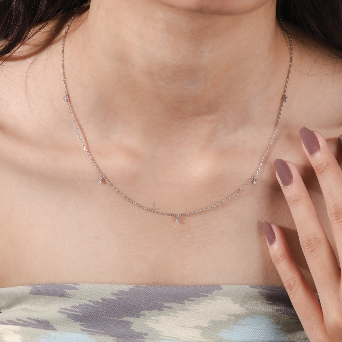 Close-up view of a yellow gold Round diamond Dangling necklace featuring multiple small prong-set round diamond charms suspended on a fine chain
