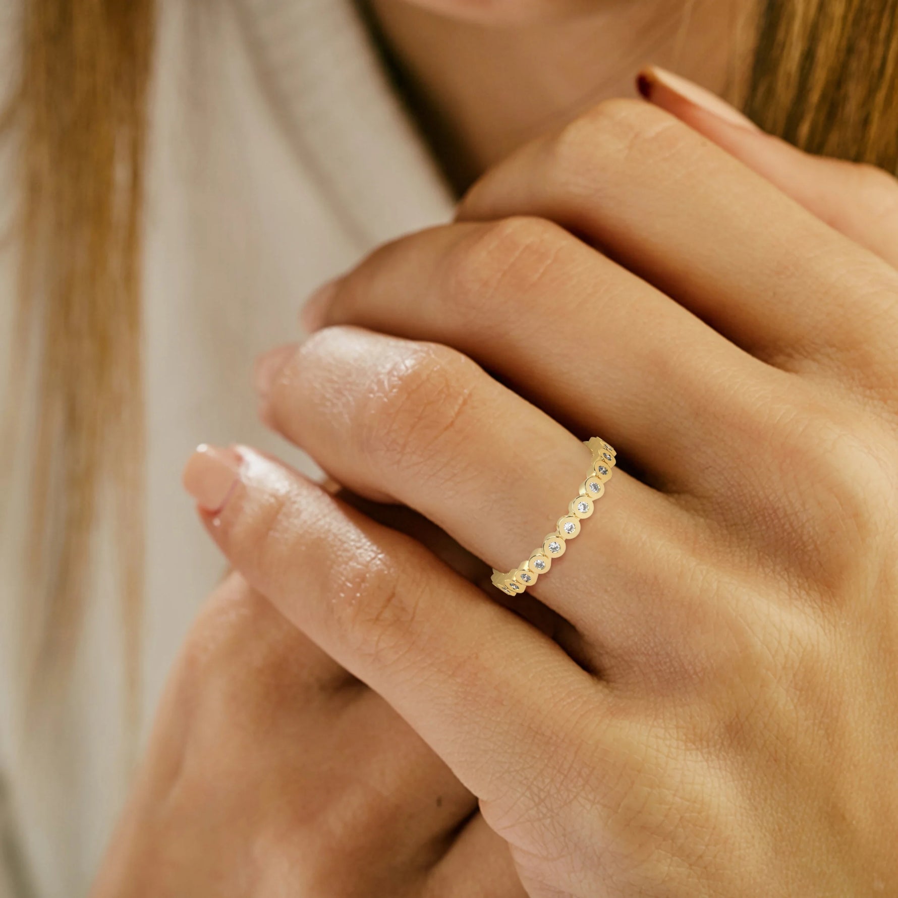 This yellow gold Full Eternity ring features round diamonds set in bezel setting on ring finger