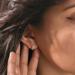 Model showcasing a wide gold hoop earring with a triple-row diamond pavé setting, ideal for daily wear or an elegant ear stack look.