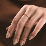 A unique yellow gold open wrap diamond ring showcasing a delicate gap design with a brilliant round diamond solitaire and pavé setting.