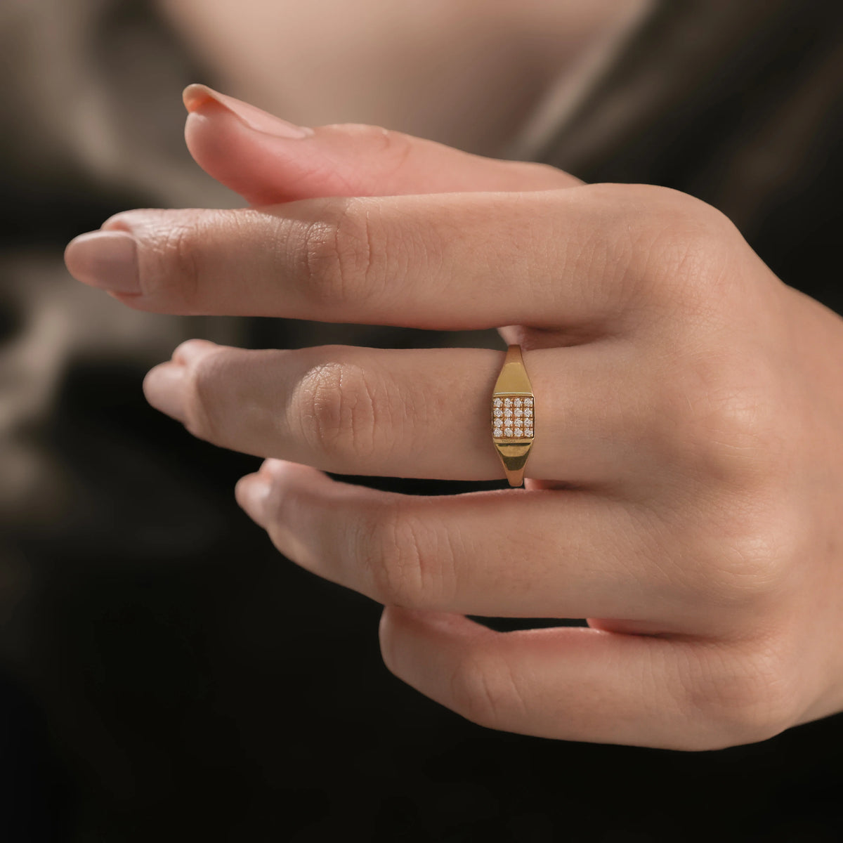 14k yellow gold signet wedding ring featuring a rectangular grid of micro pave-set diamonds, worn on a woman's ring finger.